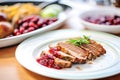 sliced meatloaf plated with cranberry sauce