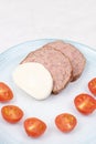 Sliced Meatloaf served with cheese and cherry tomatoes