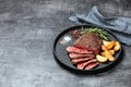 Sliced medium rare grilled beef steak and potato wedges Royalty Free Stock Photo