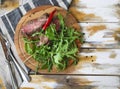 Sliced medium rare grilled Beef steak Ribeye with rocket salad o Royalty Free Stock Photo