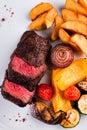 Sliced medium rare grilled Steak Ribeye with french fries Royalty Free Stock Photo