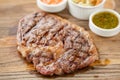 Sliced medium rare grilled Steak Ribeye with Pickled cabbage and two sauces. Serving on a wooden Board. Barbecue Royalty Free Stock Photo