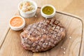 Sliced medium rare grilled Steak Ribeye with Pickled cabbage and two sauces. Serving on a wooden Board. Barbecue Royalty Free Stock Photo