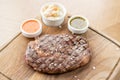 Sliced medium rare grilled Steak Ribeye with Pickled cabbage and two sauces. Serving on a wooden Board. Barbecue Royalty Free Stock Photo