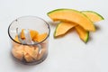 Sliced melon on table. Melon cut into pieces in blender jar Royalty Free Stock Photo