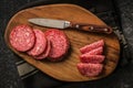 Sliced mexican salami with beans on cutting board. Top view