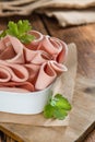 Sliced Mortadella on wooden background