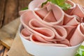 Sliced Mortadella on wooden background