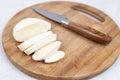 Sliced Mozarella cheese on the round wooden board Royalty Free Stock Photo