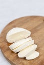 Sliced Mozarella cheese on the round wooden board Royalty Free Stock Photo