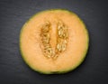 Sliced musk melon on slate. Royalty Free Stock Photo