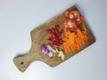 sliced onion, garlic, red pepper, carrot and tomato on wooden cutting board Royalty Free Stock Photo