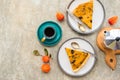 Sliced open pie with pumpkin and prunes on a ceramic plate on a gray concrete background. Pumpkin recipes. Thanksgiving desserts