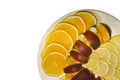 Sliced orange, apple and lemon slices on a white fruit plate on a isolated background Royalty Free Stock Photo