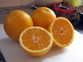 Sliced Orange Being Propped up by Whole Oranges Royalty Free Stock Photo