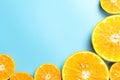 Sliced orange fruits on blue background