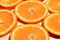 Sliced orange slices stacked in a group, angled view. Ripe juicy orange