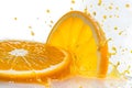 Sliced of Orange with splashing juice on white background Royalty Free Stock Photo