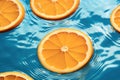 Sliced orange in transparent pool water, Creative summer composition, Refreshment concept, Healthy drink theme Royalty Free Stock Photo