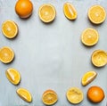 Sliced oranges and juice extractor, tiled frame blue wooden rustic background top view close up Royalty Free Stock Photo