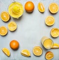 Sliced oranges and juice extractor, tiled frame blue wooden rustic background top view close up Royalty Free Stock Photo