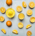 Sliced oranges, a juicer, a glass of juice wooden rustic background top view close up Royalty Free Stock Photo