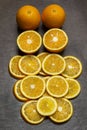 Sliced oranges and two whole oranges Royalty Free Stock Photo