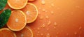 Sliced oranges with water droplets on an orange surface Royalty Free Stock Photo