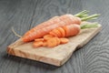 Sliced organic carrot on olive wood cutting board