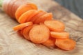 Sliced organic carrot on olive wood cutting board