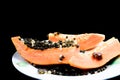 Sliced ??papaya fruit on a plate on a black background. Royalty Free Stock Photo