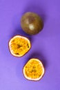 Sliced passion fruit. Fresh passion fruit on a purple background. Royalty Free Stock Photo