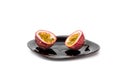 Sliced passionfruit on black plate