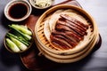 Sliced Peking Duck in bamboo steamer served with fresh cucumber and onion