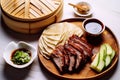 Sliced Peking Duck in bamboo steamer served with fresh cucumber and onion