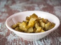 Sliced pickled cucumber in a deep plate, preparation for salad Royalty Free Stock Photo