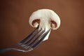 Sliced piece of champignon mushroom on a fork Royalty Free Stock Photo