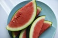 Sliced pieces of juicy red watermelon on a blue plate. Juicy fruits in summer Royalty Free Stock Photo