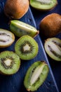 Sliced pieces of kiwi on a wooden background