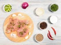 Sliced pieces of meat turkey game filet on a wooden cutting board, garlic, salt, fennel, allspice, red chili pepper, green onion, Royalty Free Stock Photo