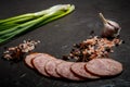 sliced pieces of smoked ham sausage with green onions and garlic Royalty Free Stock Photo