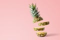 Sliced pineapple on pink bright background. Minimal fruit concept