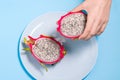 Sliced pitaya fruit. Half of the pitaya is in the hand of a man. Dragon fruit of the Hylocereus undatus species. The view from the Royalty Free Stock Photo