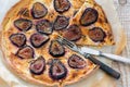 Sliced pizza with figs, fork and knife. Royalty Free Stock Photo