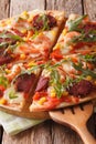 Sliced pizza with shrimp, salami, cheese and arugula close-up. V Royalty Free Stock Photo