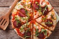 Sliced pizza with shrimp, salami, cheese and arugula closeup. ho Royalty Free Stock Photo