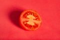 Sliced plum tomato on red Royalty Free Stock Photo