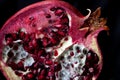 Sliced Pomegranate with arils on black glass Royalty Free Stock Photo