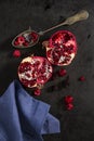 Sliced pomegranate and forest fruits with antique silver spoon. Royalty Free Stock Photo