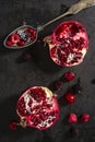 Sliced pomegranate and forest fruits with antique silver spoon. Royalty Free Stock Photo